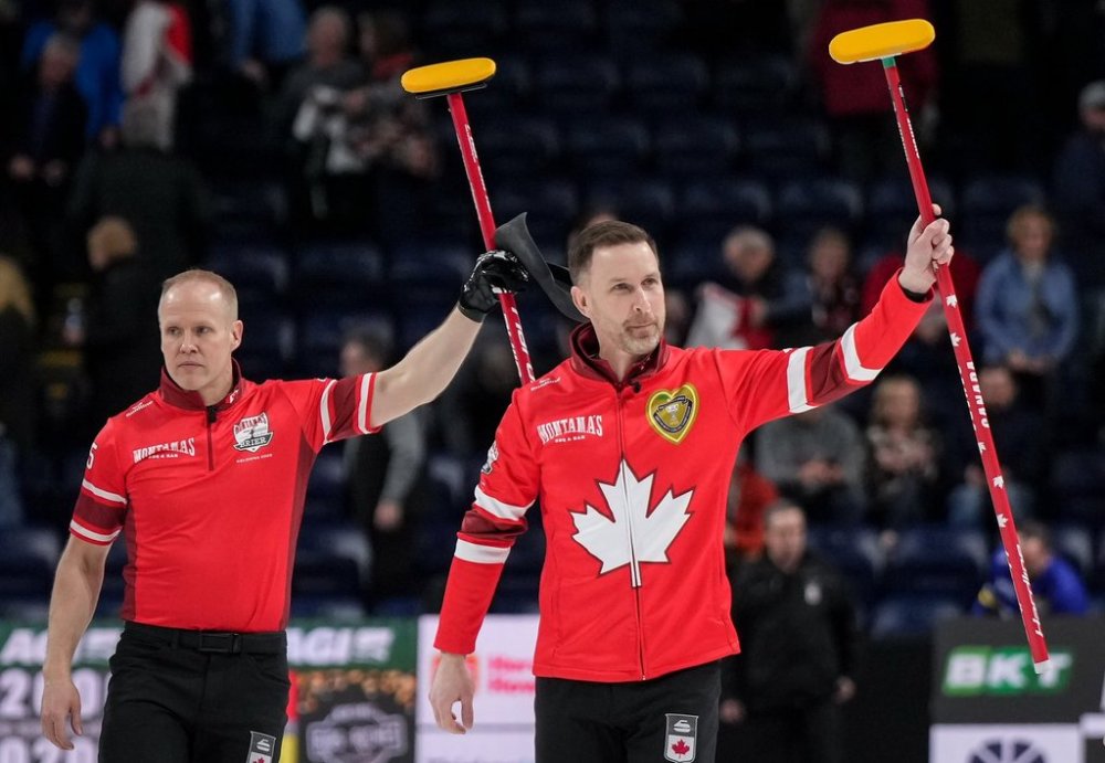 Canada skip Brad Gushue, front right, and third Mark Nichols celebrate after defeating Alberta-Jacobs during the playoffs at the Brier in Kelowna, B.C., on Friday, March 7, 2025. THE CANADIAN PRESS/Darryl Dyck