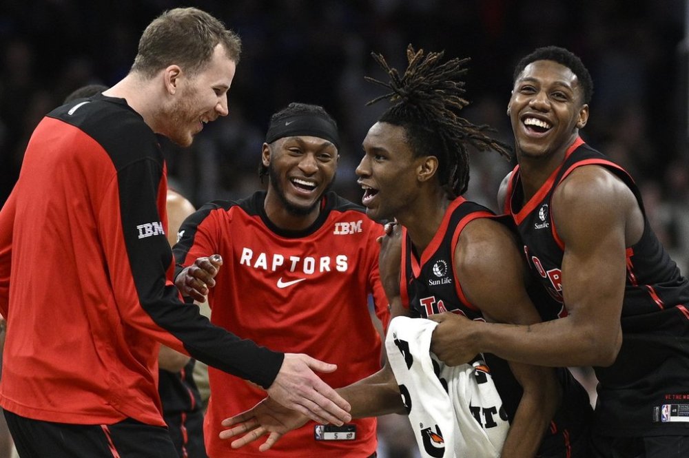 Toronto Raptors guard Ja'Kobe Walter, second from right, is congratulated by center Jakob Poeltl, left, guard Immanuel Quickley, second from left, and guard RJ Barrett, right, after his game-winning shot during the second half of an NBA basketball game against the Orlando Magic, Tuesday, March 4, 2025, in Orlando, Fla. (AP Photo/Phelan M. Ebenhack)