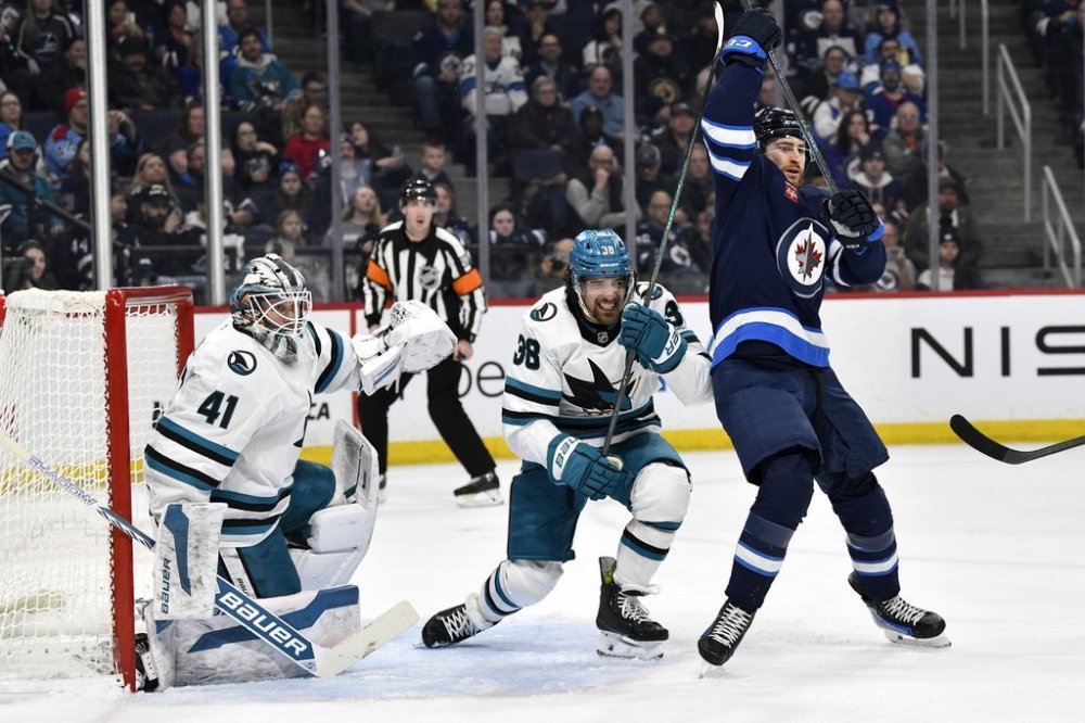 San Jose Sharks' Mario Ferraro (38) and Winnipeg Jets' Gabriel Vilardi (13) fight for position in front of goaltender Vitek Vanecek (41) during second period NHL hockey action in Winnipeg, Monday, Feb. 24, 2025. THE CANADIAN PRESS/Fred Greenslade