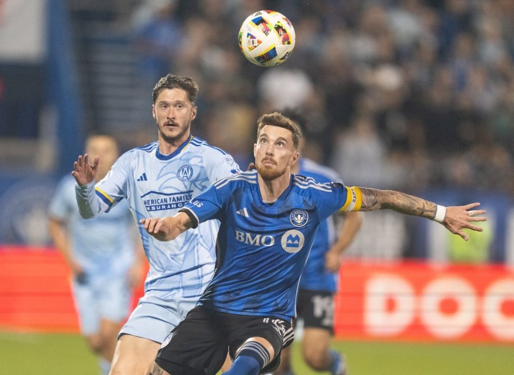 CF Montreal defender Joel Waterman (right) and Atlanta United midfielder Alexey Miranchuk (59) battle for the ball during second half MLS playoff soccer action in Montreal, Tuesday, October 22, 2024. THE CANADIAN PRESS/Christinne Muschi