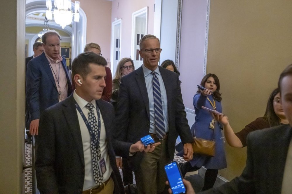 Senate Majority Leader Sen. John Thune, R-S.D., walks from the Senate chamber as the Senate works to avert a partial government shutdown ahead of the midnight deadline, at the Capitol in Washington, Friday, March 14, 2025. (AP Photo/Ben Curtis)