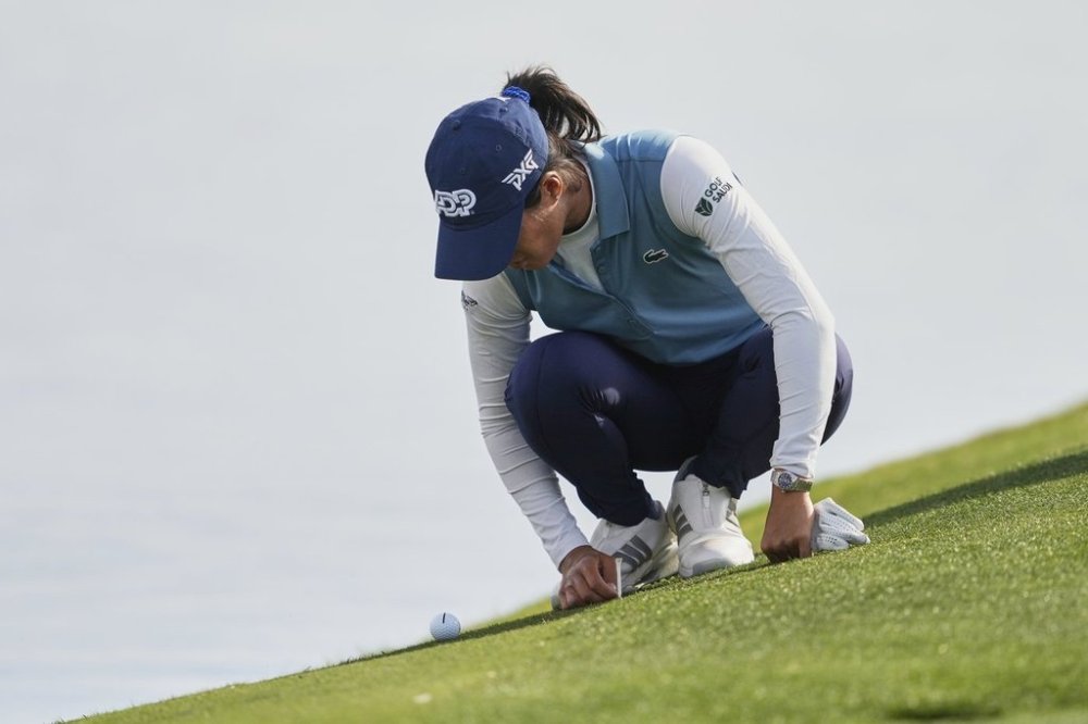 Celine Boutier, of France takes a drop on the 12th green during the second round of the Ford Championship LPGA golf event, Friday, March 28, 2025, in Phoenix. (AP Photo/Matt York)