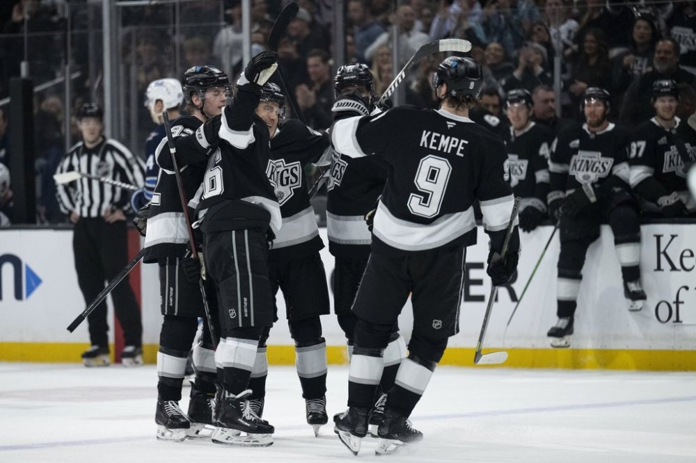 Los Angeles Kings players celebrate a goal by left wing Andrei Kuzmenko during the second period of an NHL hockey game against the Winnipeg Jets, Tuesday, April 1, 2025, in Los Angeles. (AP Photo/Kyusung Gong)