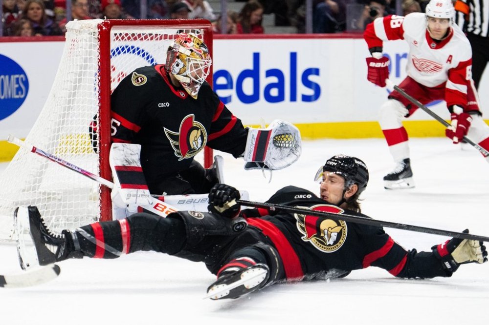 Ottawa Senators defenceman Jake Sanderson (85), bottom, blocks a shot as teammate Linus Ullmark (35) looks on during first period NHL hockey action against the Detroit Red Wings in Ottawa, on Monday, March 10, 2025. THE CANADIAN PRESS/Spencer Colby