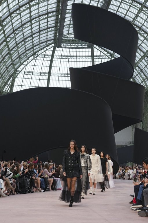 Vittoria Ceretti leads other models as they wear creations as part of the Chanel Fall/Winter 2025-2026 Womenswear collection presented Tuesday, March 11, 2025. in Paris. (Photo by Scott A Garfitt/Invision/AP)