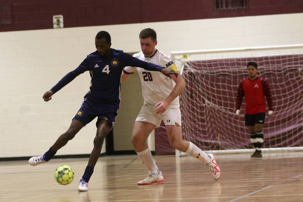 BU's Awall Osabutey dribbles while AC's Vadym Kochenko defends on Saturday. The Cougars put together a strong defensive performance to finish in third place in the regular season. (Thomas Friesen/The Brandon Sun)