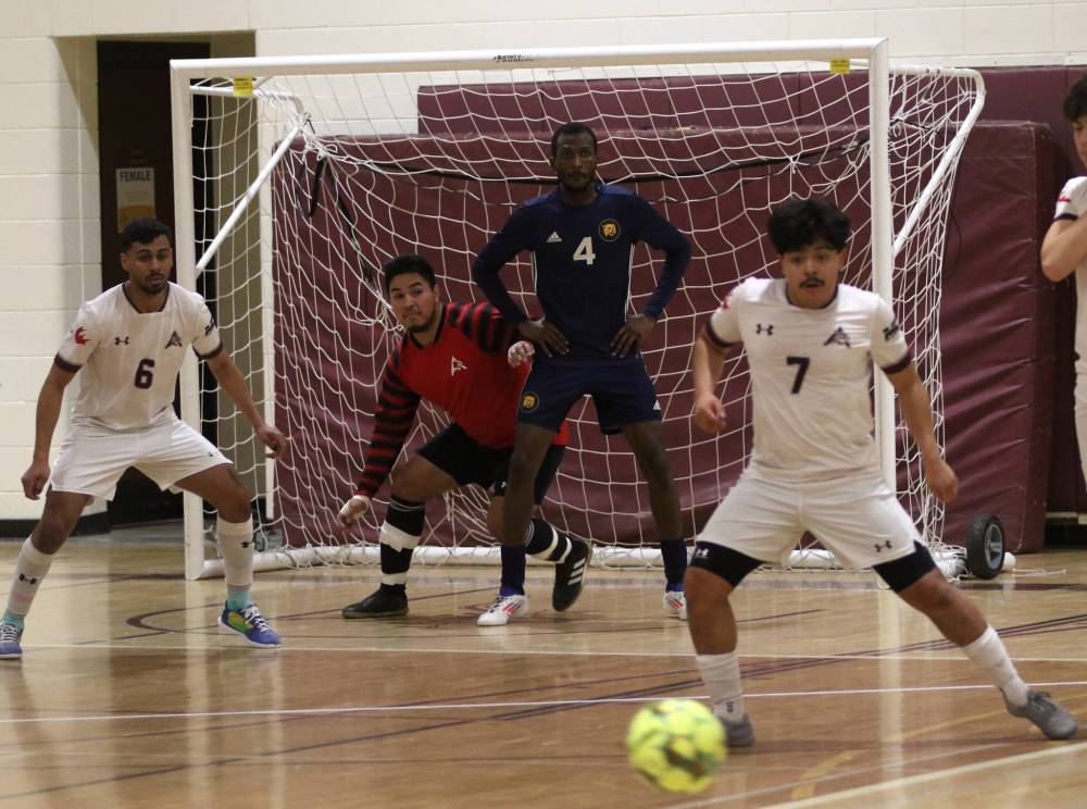 Assiniboine College goalkeeper Gerardo Alas, shown navigating Brandon University's Awall Osabutey's screen while flanked by teammates Paulo Pinto (6) and Benny Torres, carried the Cougars to a 2-1 win over the Bobcats on Saturday to secure a Manitoba Colleges Athletic Conference men's futsal playoff spot. (Thomas Friesen/The Brandon Sun)