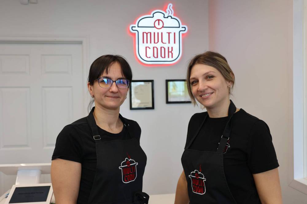 Multi Cook Brandon owners Oksana Golovka (left) and Katervna Doboshynska (right) pose for a picture at the front of the business on Monday afternoon. (Abiola Odutola/The Brandon Sun)