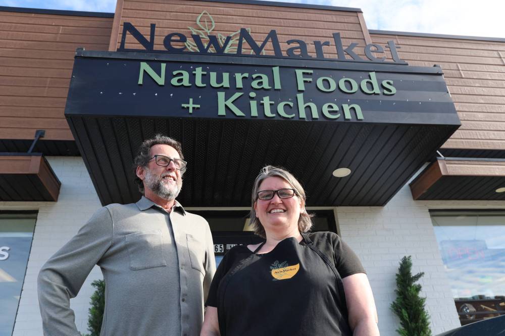 New Market Natural Foods and Kitchen co-owners Cam Wirch (left) and Kim Koversky pose for a picture in front of the store at the end of February. The local-food business is protected in some ways against tariffs, the owners said, because the large majority of their products and sales come from Canada. Koversky said about three per cent of their products are from the U.S. (Abiola Odutola/The Brandon Sun, file)