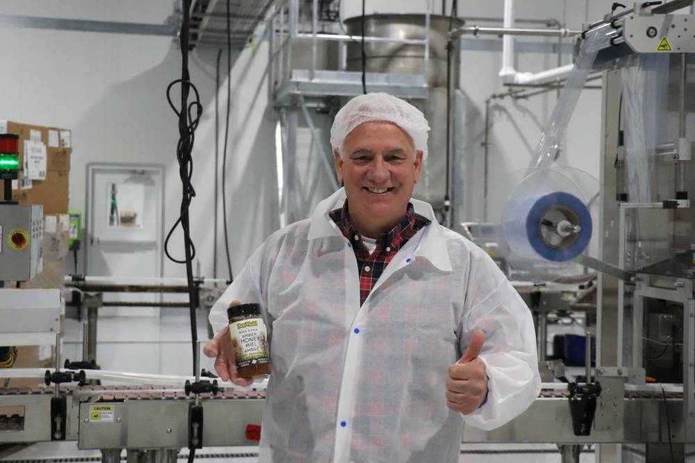 Bee Maid CEO Guy Chartier is seen in the company’s new packing facility in Winnipeg. The beekeeper co-operative packs upwards of 20 million pounds of honey per year and sells most products inside Canada. (Submitted)