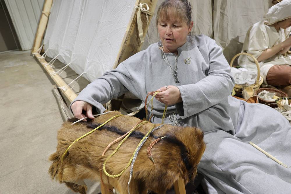 Vikings re-enactor Lesley Lindal-Dobson presents her collection of historically inspired jewelry during the expo.