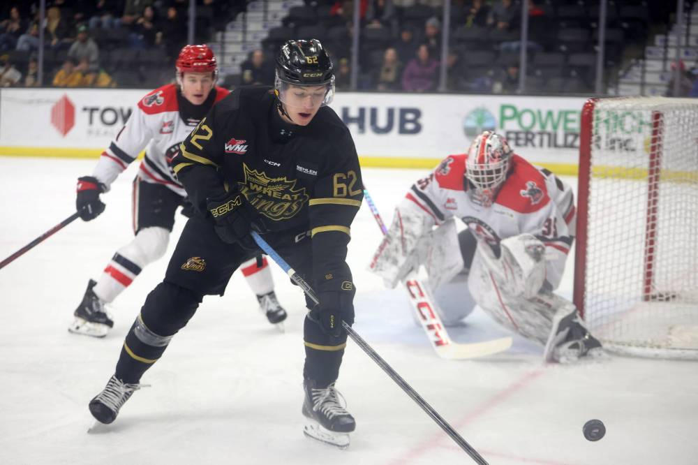 Nicholas Johnson of the Brandon Wheat Kings works to get his stick on the puck in front of Moose Jaw goalie Joshua Banini. (Tim Smith/The Brandon Sun)