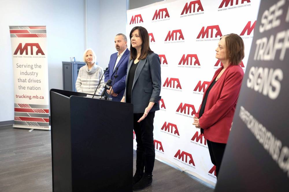 Janet Campbell, president and CEO of The Joy Smith Foundation, speaks to reporters with Crime Stoppers’ Robert MacKenzie, along with representatives with the Manitoba Trucking Association on Thursday. (Ruth Bonneville/Winnipeg Free Press)