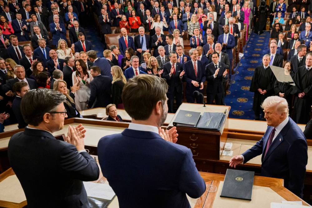 U.S. President Donald Trump (right) is applauded by Vice-President JD Vance (centre) and Speaker of the House Mike Johnson, R-La. (left) as he arrives to address a joint session of Congress at the Capitol in Washington last week. Matthew Lebo writes that with a new prime minister and a federal election looming in Canada, the current situation in the U.S. provides valuable lessons, since it’s “important to know the warning signs of extremism and anti-democratic practices that are creeping into our politics.” (The Associated Press files)