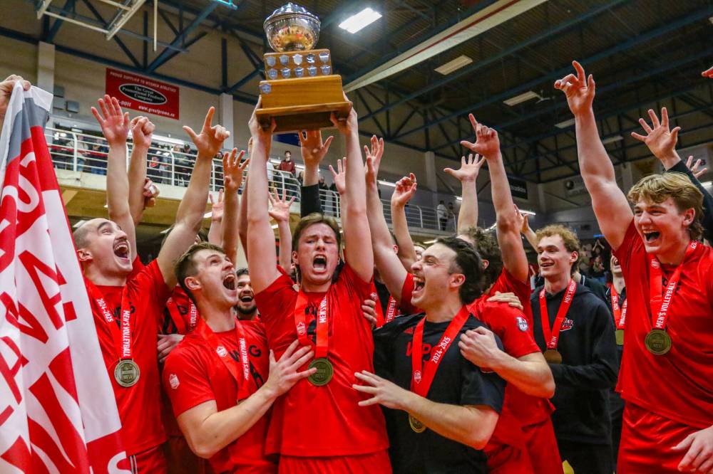 Winnipeg Wesmen setter Ben Traa hoists the Canada West men’s volleyball trophy after the Wesmen claimed it for the first time on home court two weeks ago. (David Larkins/Wesmen Athletics)