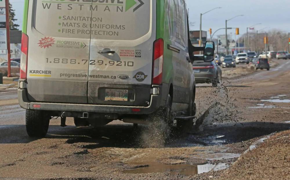 A vehicle is seen driving through a line of water-filled potholes on Richmond Avenue. CAA Manitoba has launched its annual Worst Roads Campaign, with nominations open until April 11. (The Brandon Sun files)