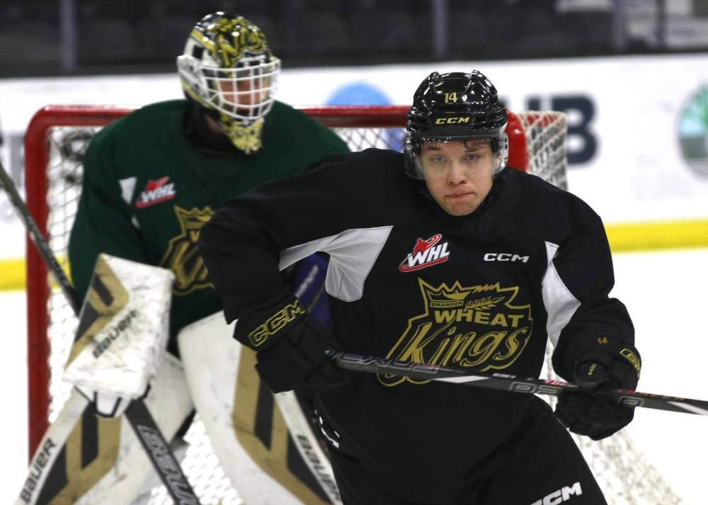 Brandon Wheat Kings defenceman Adam Belusko defends the net in front of goaltender Carson Bjarnason during Tuesday's practice at Westoba Place. (Perry Bergson/The Brandon Sun)