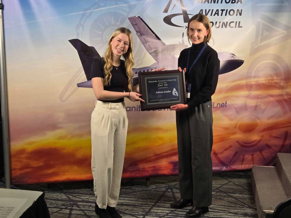 Fast Air representative O’Danis Fast (right) presents the Manitoba Aviation Scholarship to Brandon Flight Centre student Ashton Osudar. (Submitted)