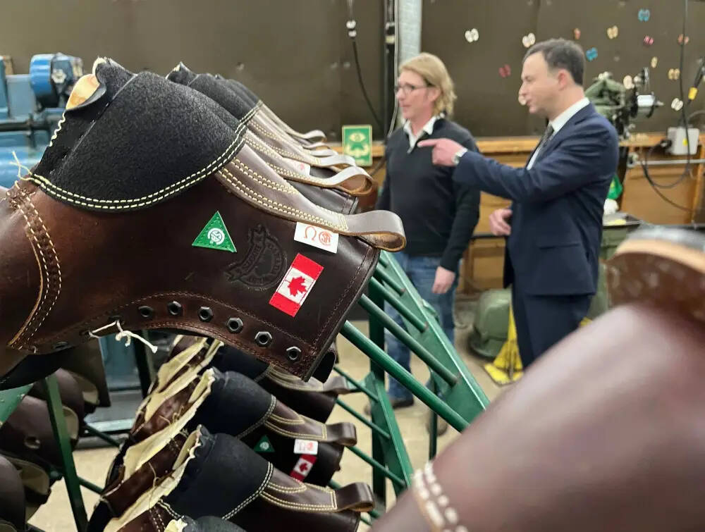 Manitoba Finance Minister Adrien Sala continues the tradition of new shoes for budget day, touring Canada West Boots with company president Graham Moorby Wednesday. It’s expected that the province will waive entry fees to parks for one year. (Mike Aporius/Winnipeg Free Press)