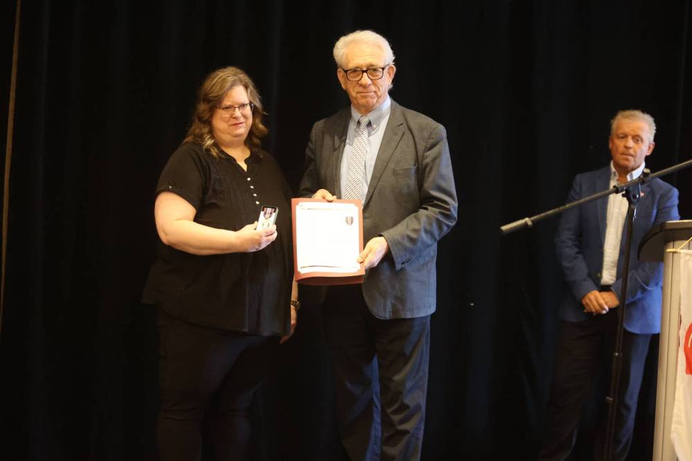 Brandon-Souris MP Larry Maguire presents the King Charles III Coronation Medal to United Way Brandon & District CEO Cynamon Mychasiw during Friday’s event. (Abiola Odutola/The Brandon Sun)