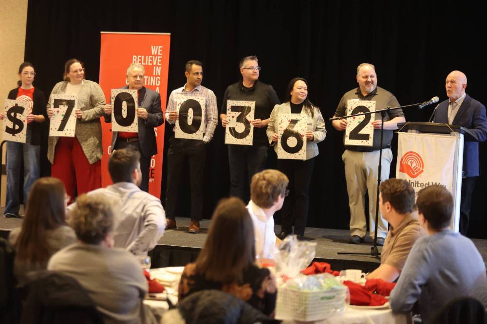 United Way Brandon & District 2024 campaign chair Barry Cooper (right) presents the total amount of donations raised in 2024 to the audience during the organization’s annual touchdown and volunteer appreciation event Friday afternoon at the Victoria Inn. (Abiola Odutola/The Brandon Sun)