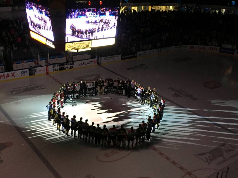 The Brandon Wheat Kings and Lethbridge Hurricanes gather at centre ice prior to Game 2 of their Eastern Conference semifinal on Saturday, April 7, 2018 at the Enmax Centre in Lethbridge for a memorial to the Humboldt Broncos players bus crash that killed 15 players and staff. The collision took place on Friday, but the players didn't learn of the tragedy until after Game 1 of the Western Hockey league series ended. (Perry Bergson/The Brandon Sun)