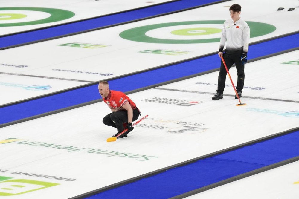 Canada skip Brad Jacobs watches his stone as China's Zhiyu Wang looks on during the bronze-medal game at the BKT World Men's Curling Championship in Moose Jaw, Sask., on Sunday, April 6, 2025. THE CANADIAN PRESS/Chris Young
