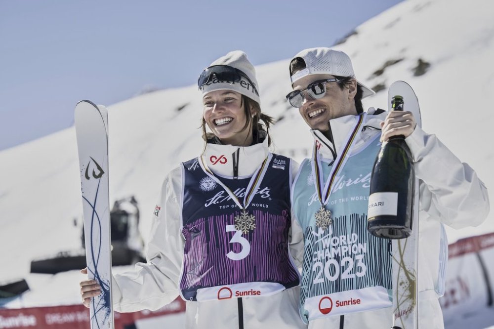 Canada's Maia Schwinghammer, bronze medalist in a women's moguls, celebrates with compatriot siler medalist in the men's moguls Mikael Kingsbury, at the Freestyle World Championships, in St. Moritz, Switzerland, Wednesday, March 19, 2025. (Gian Ehrenzeller/Keystone via AP)