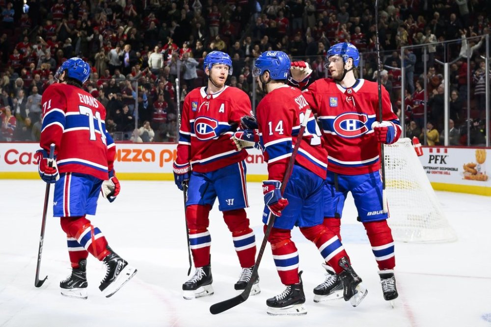 Montreal Canadiens centre Nick Suzuki (14), celebrates with teammates Jake Evans (71), Mike Matheson (8) and Joel Armia (40) after scoring during third period NHL hockey action against the Boston Bruins in Montreal, on Thursday, April 3, 2025. THE CANADIAN PRESS/Christopher Katsarov