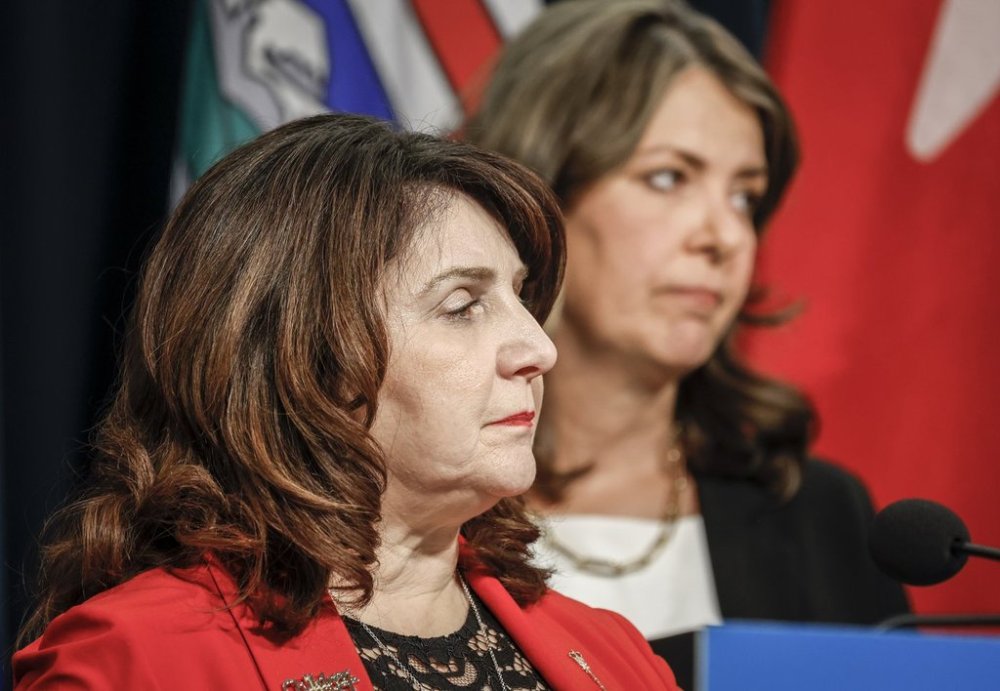 Alberta Premier Danielle Smith, right, and Minister of Health Adriana LaGrange speak during a press conference in Calgary, Alta., Wednesday, Feb. 19, 2025. THE CANADIAN PRESS/Jeff McIntosh