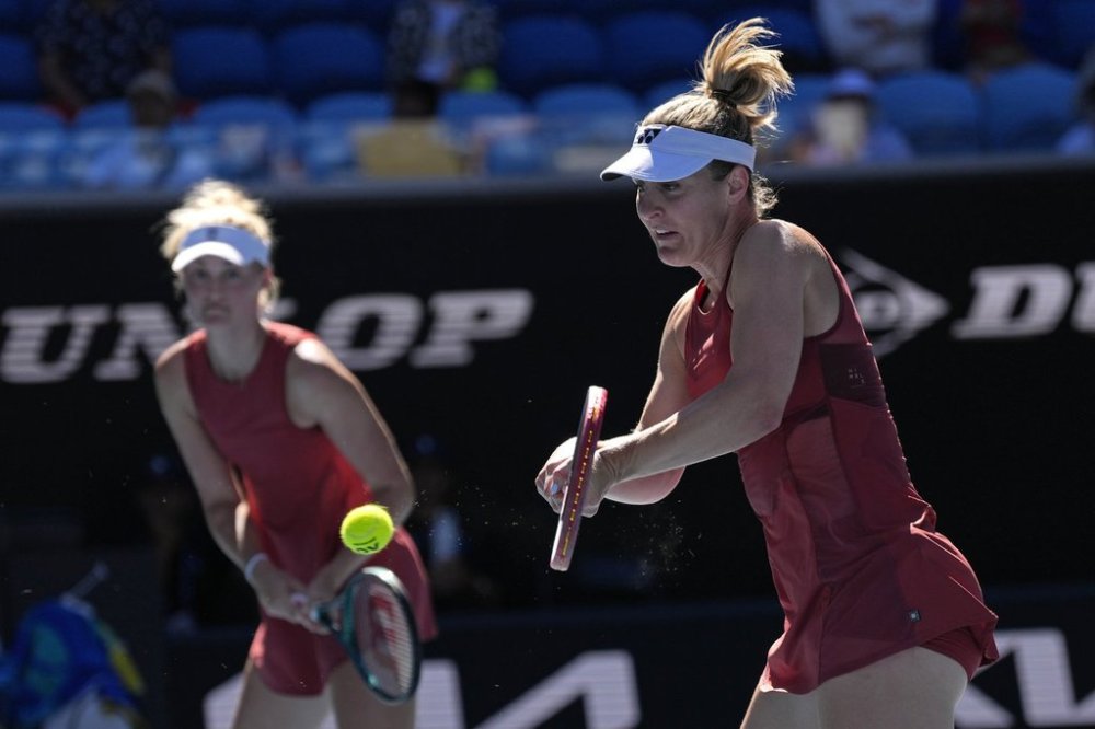 Canada's Gabriela Dabrowski, right, and partner Erin Routliffe of New Zealand in action their women's doubles semifinal against Hsieh Su-Wei of Taiwan and Jelena Ostapenko of Latvia at the Australian Open tennis championship in Melbourne, Australia, Friday, Jan. 24, 2025. (AP Photo/Ng Han Guan)