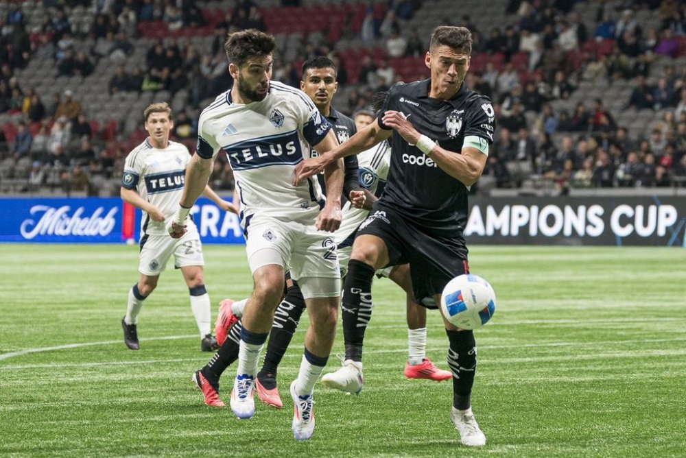 Vancouver Whitecaps FC's Brian White (left) and CF Monterrey's Hector Moreno battle for control of the ball during the second half of CONCACAF Champions Cup soccer action in Vancouver, B.C., Wednesday, March 5, 2025. THE CANADIAN PRESS/Rich Lam