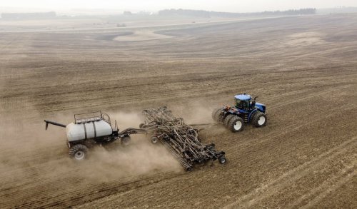 David Reid drives a seeding rig as he plants a canola crop on the family's farm near Cremona, Alta., Tuesday, May 16, 2023. THE CANADIAN PRESS/Jeff McIntosh