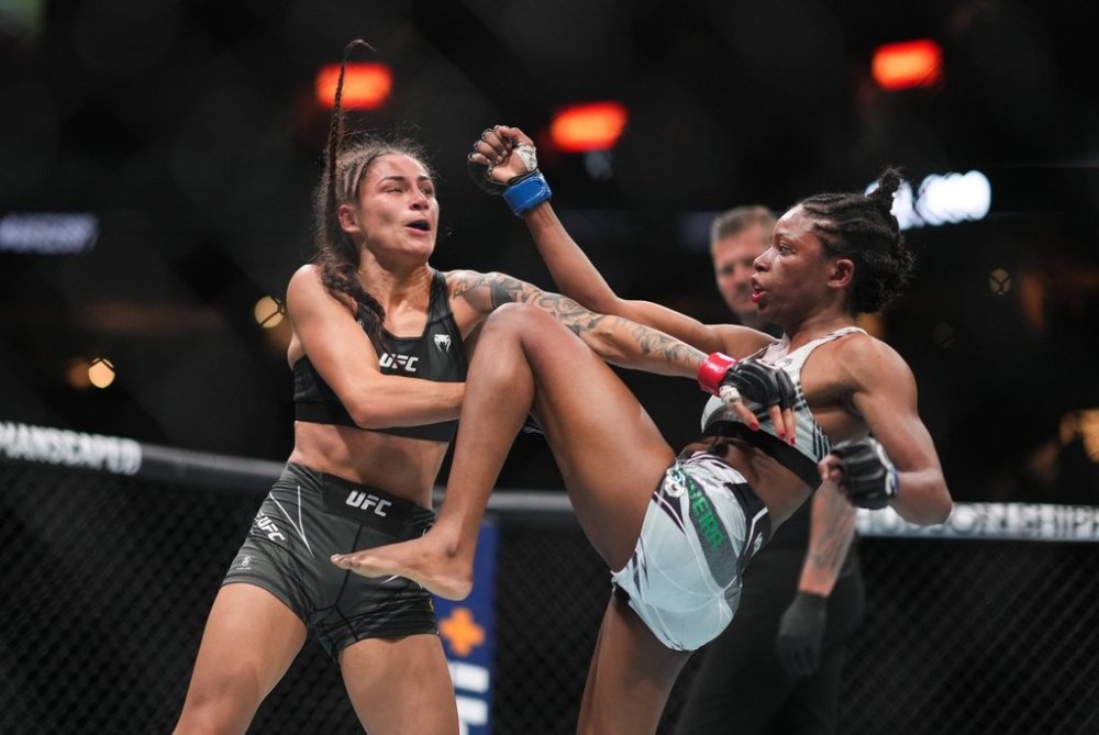 Diana Belbita, left, and Maria Oliveira fight during a UFC 289 women's strawweight bout, in Vancouver, on Saturday, June 10, 2023. THE CANADIAN PRESS/Darryl Dyck