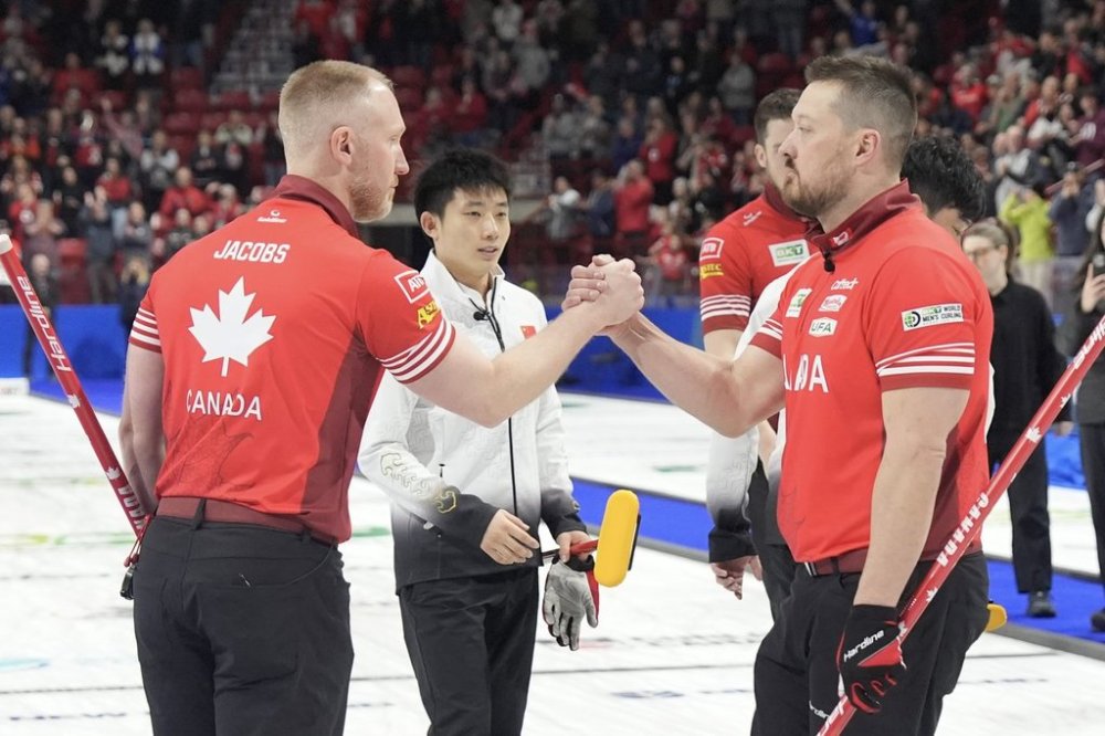 Skip Brad Jacobs congratulates lead Ben Hebert after Canada's 11-2 win over China in the bronze-medal game at the BKT World Men's Curling Championship in Moose Jaw, Sask., on Sunday, April 6, 2025. THE CANADIAN PRESS/Chris Young