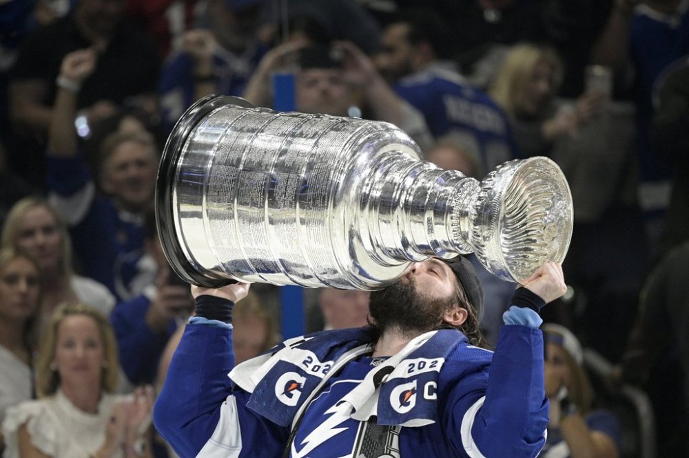 FILE - Tampa Bay Lightning left wing Pat Maroon kisses the Stanley Cup after getting the win over the Montreal Canadiens in Game 5 of the NHL hockey Stanley Cup finals series, Wednesday, July 7, 2021, in Tampa, Fla. (AP Photo/Phelan M. Ebenhack, File)
