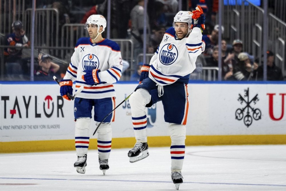 Edmonton Oilers center Leon Draisaitl (29) celebrates scoring the winning goal in overtime of an NHL hockey game against the New York Islanders, Friday, March 14, 2025, in Elmont, N.Y. (AP Photo/Angelina Katsanis)