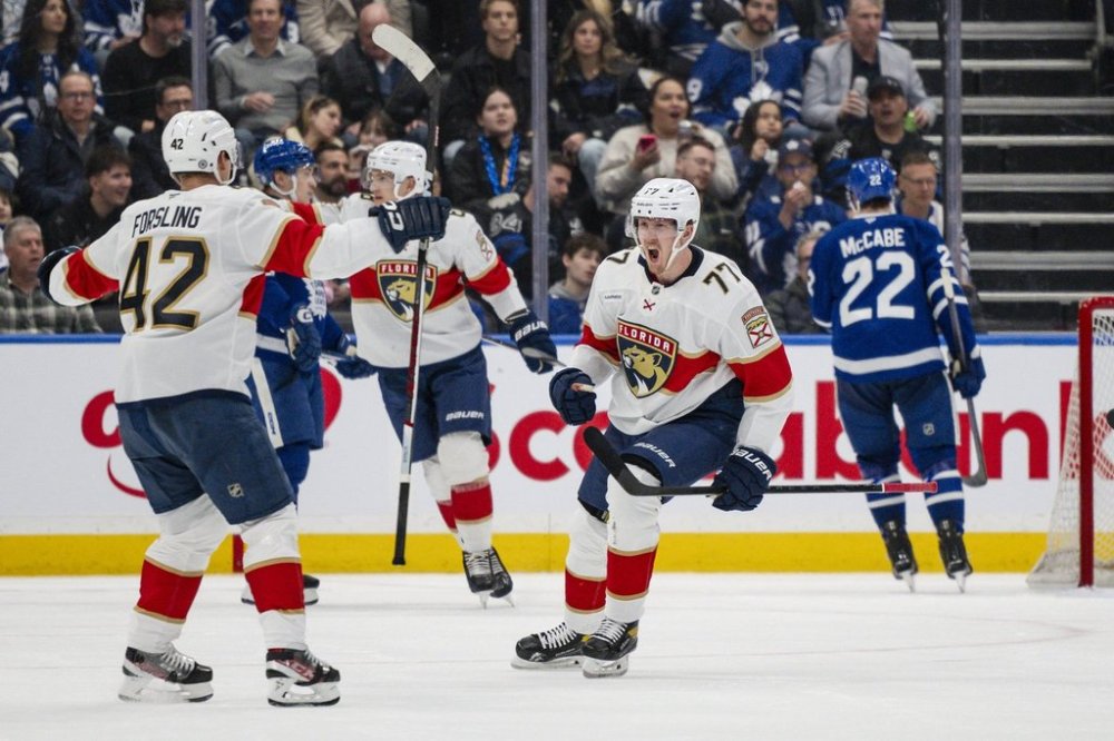 Florida Panthers' Niko Mikkola (77) celebrates with Gustav Forsling (42) after scoring during second period NHL hockey action against the Toronto Maple Leafs in Toronto, on Thursday, March 13, 2025. THE CANADIAN PRESS/Christopher Katsarov