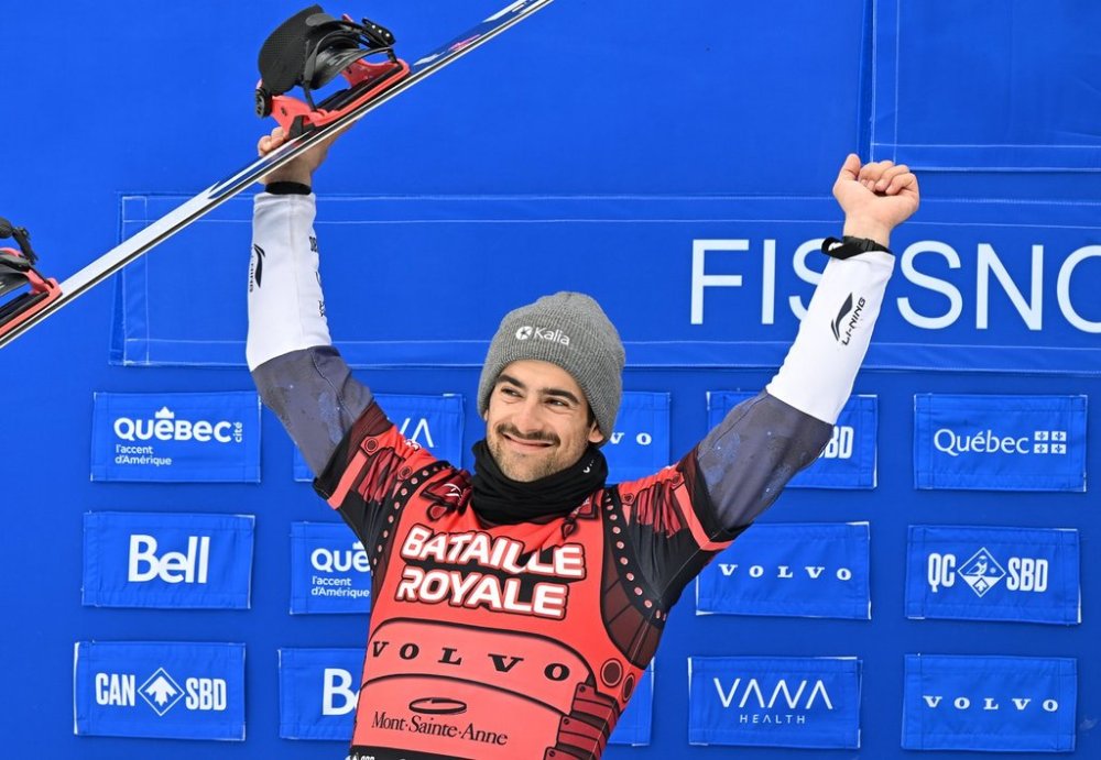 Eliot Grondin of Sainte-Marie Que., celebrates his second place finish in the final which secures the Crystal Globe for the season’s championship at the FIS Snowboard Cross World Cup event at Mont-Sainte-Anne resort in Beaupre Que.Saturday, April 5, 2025 THE CANADIAN PRESS/Jacques Boissinot