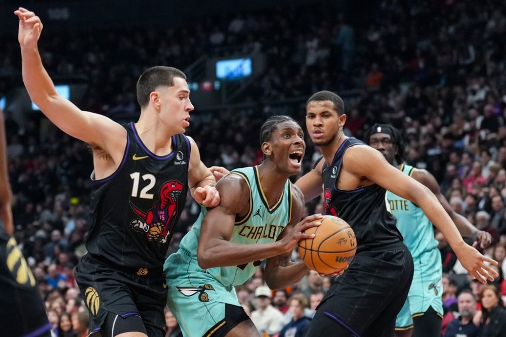 Toronto Raptors forward Cole Swider (12) and centre Orlando Robinson (21) guard Charlotte Hornets forward Moussa Diabate (centre) during first half NBA basketball action in Toronto on Friday, March 28, 2025. The Toronto Raptors signed forward Cole Swider for the remainder of the season Saturday. The six-foot-eight, 220-pound Swider is averaging 6.5 points, 2.3 rebounds and 17.8 minutes in six games with the Raptors after signing a 10-day contract last month. THE CANADIAN PRESS/Arlyn McAdorey