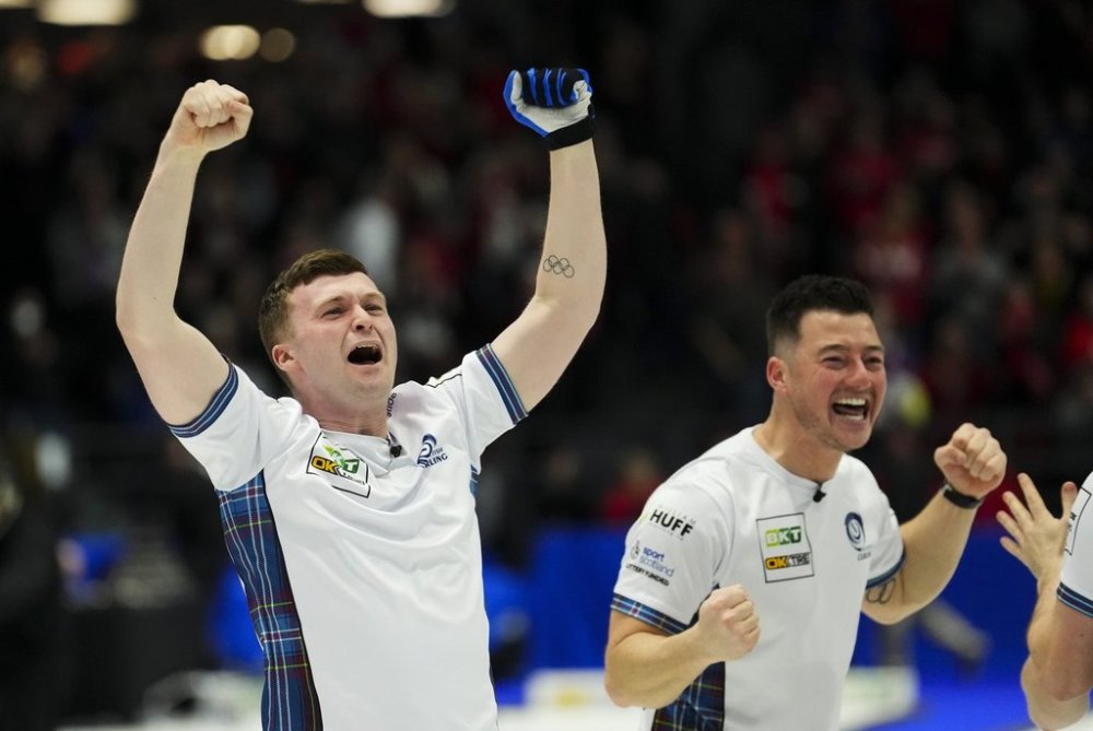 Scotland skip Bruce Mouat celebrates his gold-medal win alongside lead Hammy McMillan at the Men's World Curling Championship in Ottawa on Sunday, April 9, 2023. Scotland defeated Canada 9-3. THE CANADIAN PRESS/Sean Kilpatrick