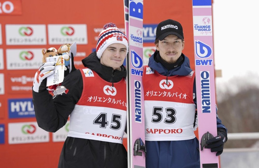 Second placed Marius Lindvik, left, of Norway, and third placed Johann Forfang of Norway pose together on the podium during the men's Ski Jumping World Cup event in Sapporo, northern Japan Sunday, Feb. 16, 2025. (Kyodo News via AP)
