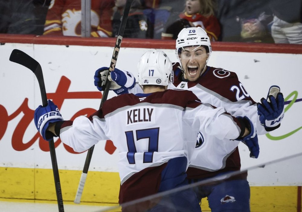 Colorado Avalanche's Parker Kelly, left, celebrates his goal with teammate Ross Colton during third period NHL hockey action against the Calgary Flames in Calgary on Friday, March 14, 2025.THE CANADIAN PRESS/Jeff McIntosh