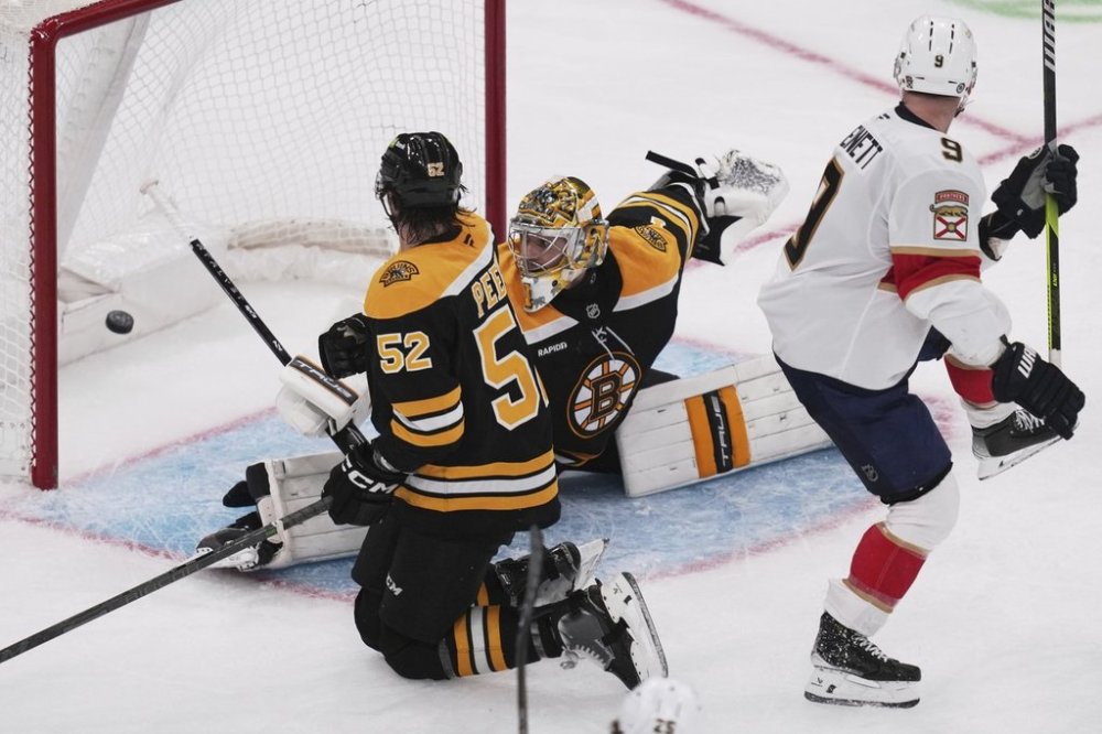 Boston Bruins goaltender Jeremy Swayman stretches but can't make the save on a goal by Florida Panthers right wing Mackie Samoskevich during the third period of an NHL hockey game, Tuesday, March 11, 2025, in Boston. (AP Photo/Charles Krupa)