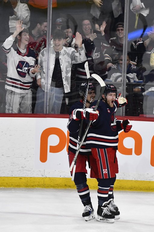 Winnipeg Jets' Nikolaj Ehlers (right) celebrates his game-winning goal in overtime against the Washington Capitals with Mark Scheifele (55) during their NHL hockey game in Winnipeg, Tuesday March 25 2025. THE CANADIAN PRESS/Fred Greenslade