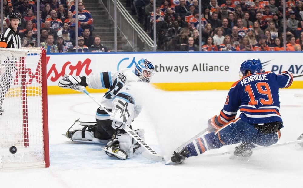 Utah Hockey Club goalie Jaxson Stauber (33) makes the save on Edmonton Oilers' Adam Henrique (19) during second period NHL action in Edmonton on Tuesday, March 18, 2025. THE CANADIAN PRESS/Jason Franson