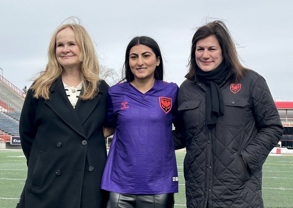 Northern Super League president Christina Litz, left, Calgary Wild FC player Farkhunda Muhtaj and Wild FC CEO Lara Murphy show the Wild's home jersey, in Calgary, Alta., Thursday, March 20, 2025. Wild FC will visit the Vancouver Rise on April 16 to launch the Canadian women's pro soccer league. THE CANADIAN PRESS/Donna Spencer