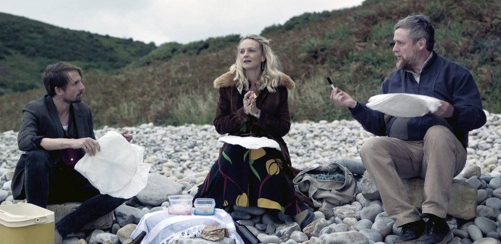This image released by Focus Features shows Tom Basden, from left, Carey Mulligan and Tim Key in a scene from