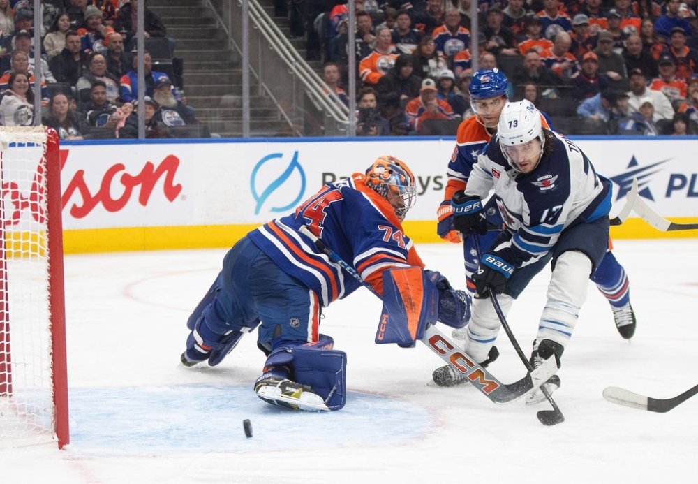 Winnipeg Jets' Brandon Tanev (73) scores a goal on Edmonton Oilers goalie Stuart Skinner (74) during third period NHL action in Edmonton on Thursday, March 20, 2025. THE CANADIAN PRESS/Jason Franson