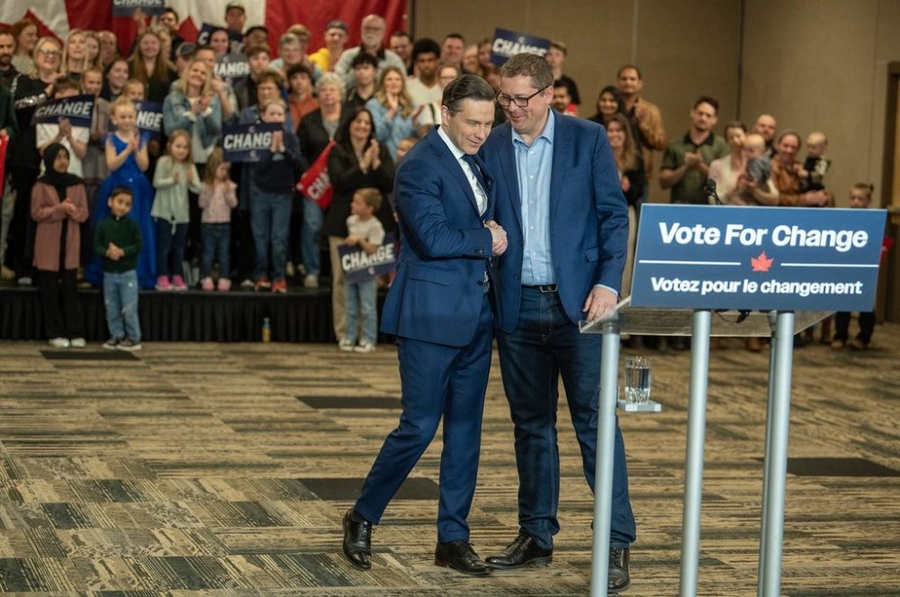 Leader of the Conservative Party of Canada Pierre Poilievre, left, shakes hands with candidate and current MP Andrew Scheer speaks at a media event in Saskatoon, Sask., Friday, April 25, 2025. THE CANADIAN PRESS/Liam Richards